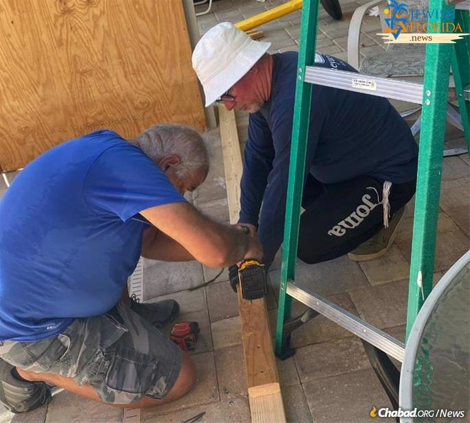 At Chabad of Venice, Pinchas Shmonim, right, a recent refugee from Ukraine, could be found building the community sukkah with resident Alex Azizov.